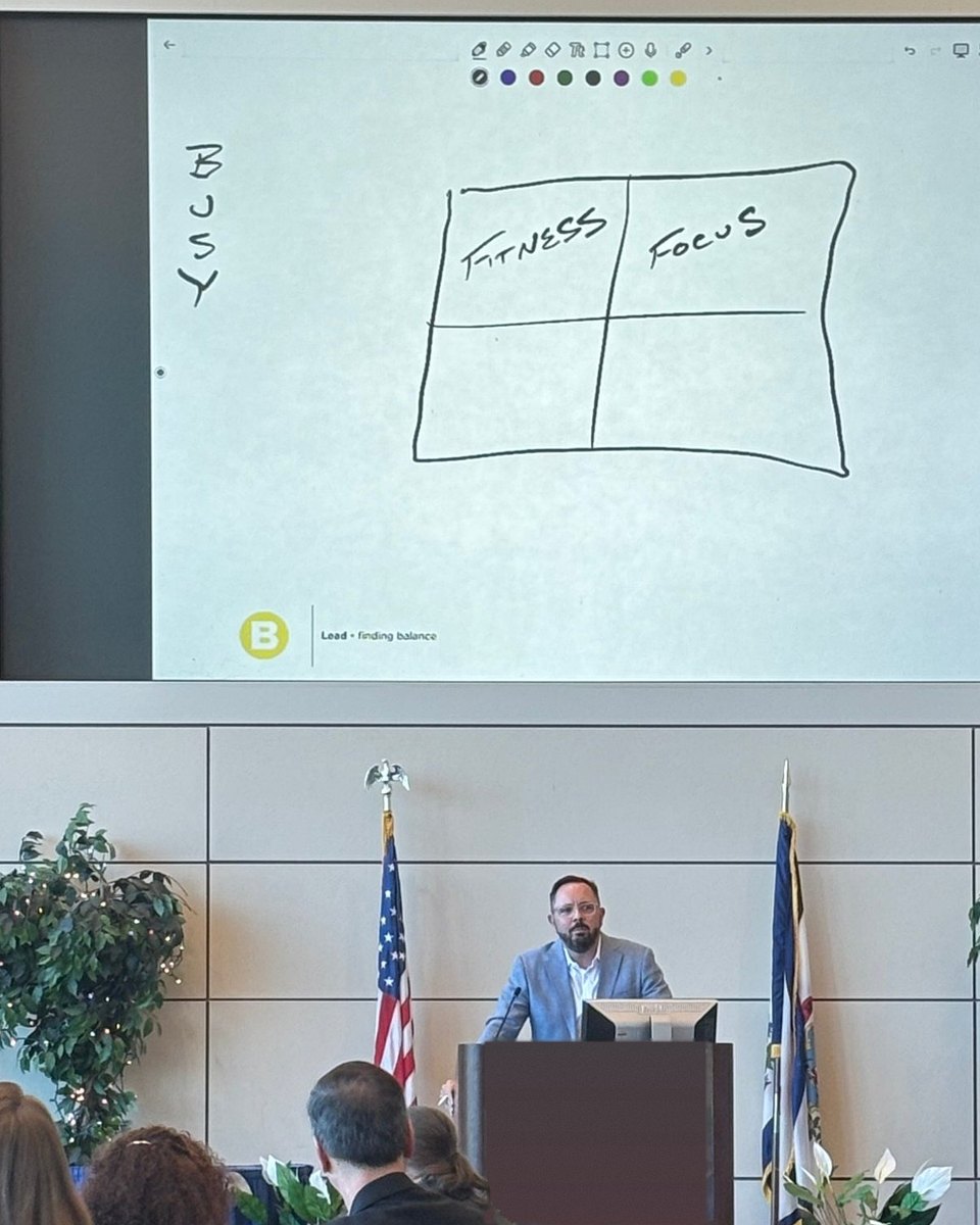 David Wible speaking, with the F4 sketch he drew on the screen behind him